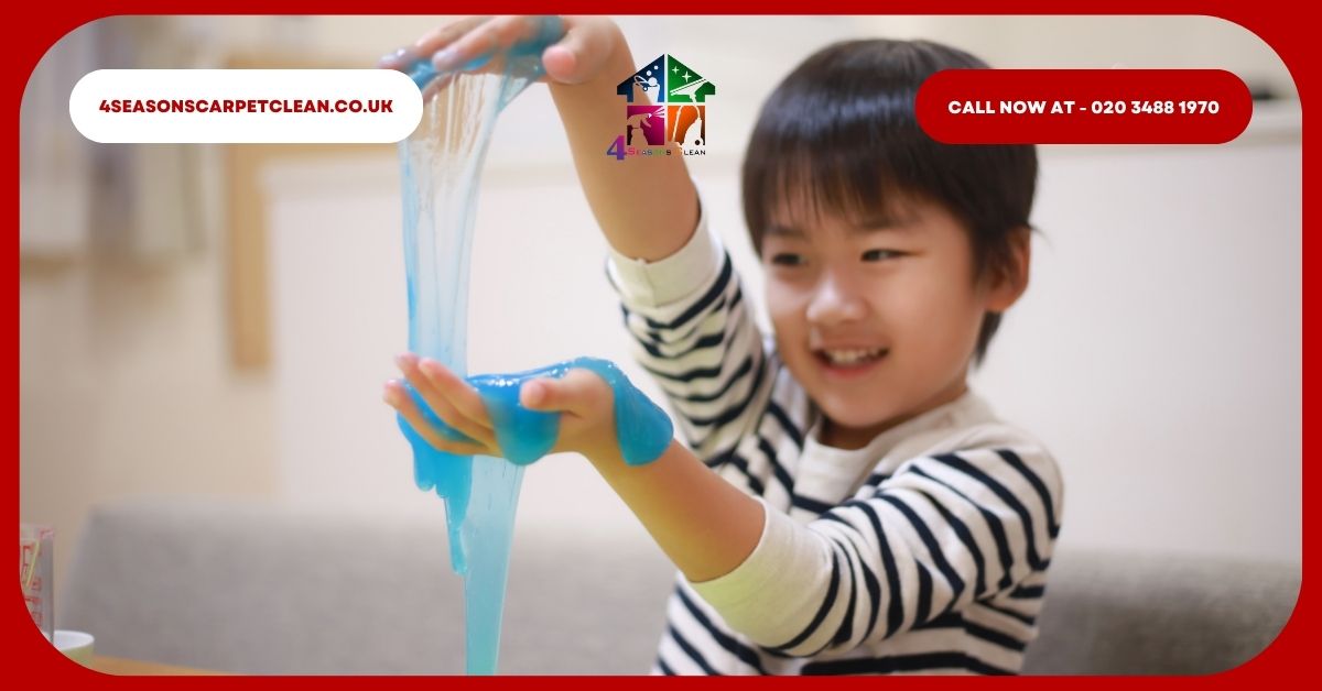 A child playing with slime, with some of it on the carpet